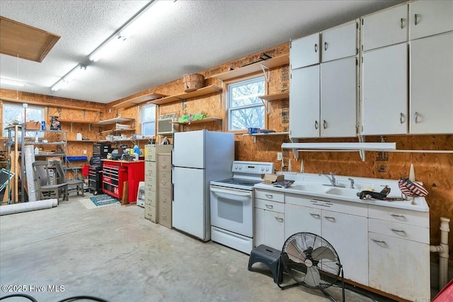 kitchen featuring concrete floors, a textured ceiling, white appliances, white cabinetry, and open shelves