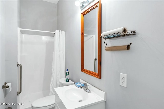 bathroom featuring vanity, toilet, and a shower stall