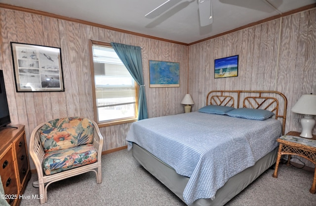 bedroom with carpet floors, ornamental molding, and a ceiling fan