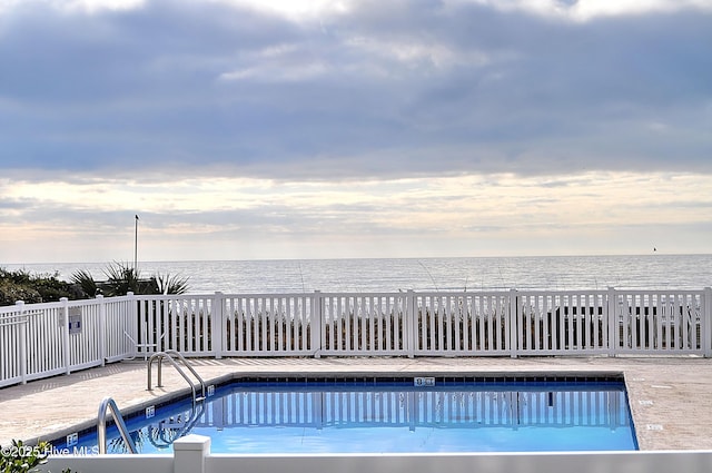 pool featuring a water view and fence