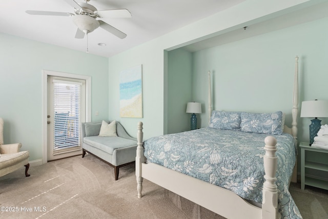 carpeted bedroom with ceiling fan and baseboards