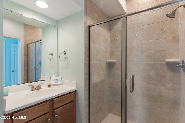 full bath featuring a stall shower and vanity