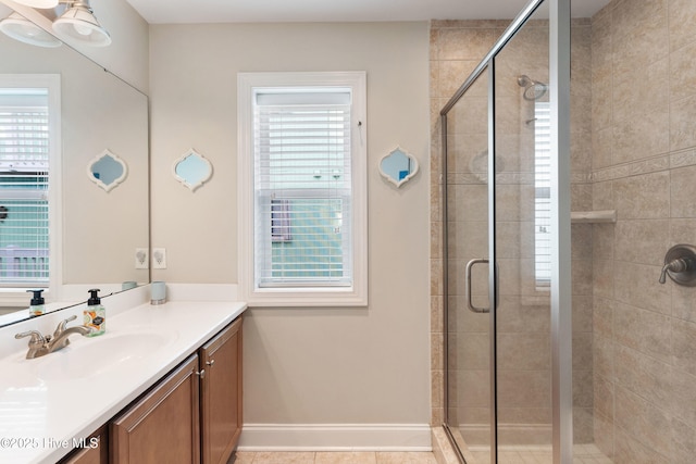 bathroom with a shower stall, vanity, and baseboards