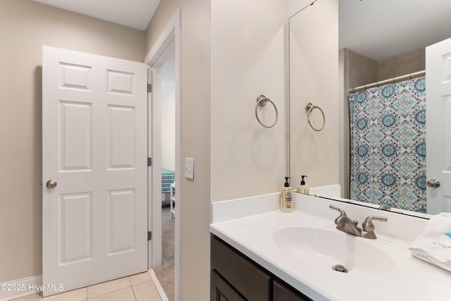 full bathroom with a shower with shower curtain, vanity, and tile patterned floors