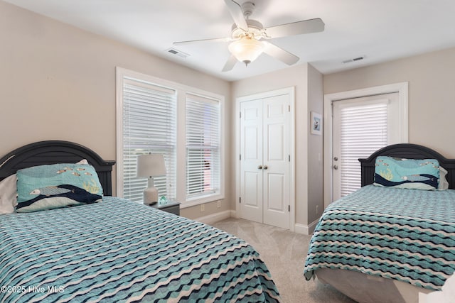 carpeted bedroom featuring ceiling fan, visible vents, and baseboards