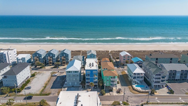 birds eye view of property featuring a beach view, a residential view, and a water view