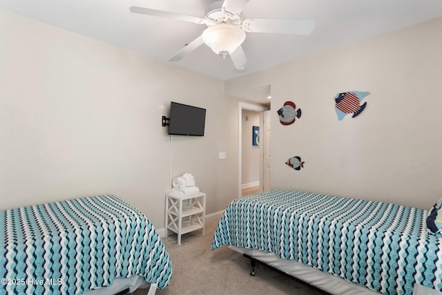 carpeted bedroom featuring a ceiling fan and baseboards