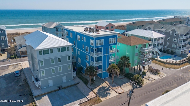 bird's eye view with a beach view, a water view, and a residential view