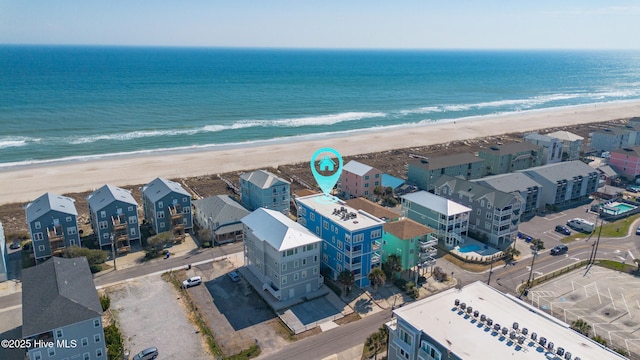 drone / aerial view with a water view and a beach view