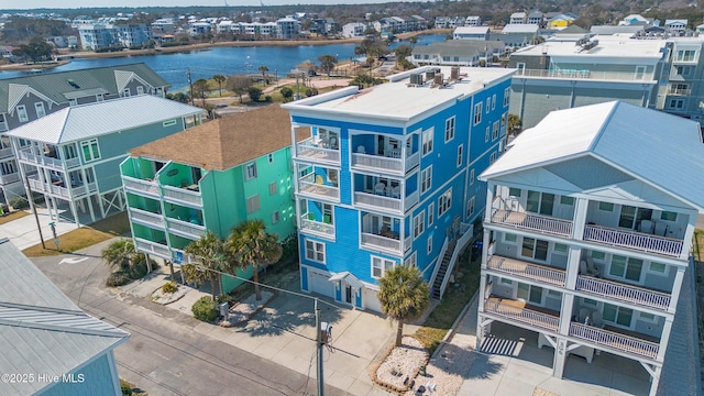 birds eye view of property with a water view and a residential view