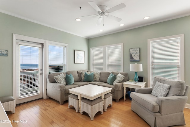 living room featuring light wood-style flooring, ornamental molding, ceiling fan, and recessed lighting