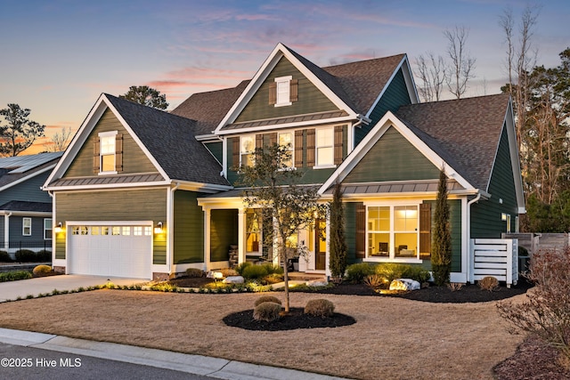 craftsman inspired home featuring a standing seam roof, driveway, covered porch, an attached garage, and a shingled roof