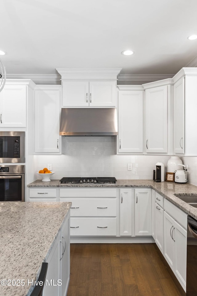 935 Baldwin Park Dr, Wilmington, NC 28411 - kitchen featuring appliances with stainless steel finishes, under cabinet range hood, white cabinets, dark wood finished floors, and recessed lighting