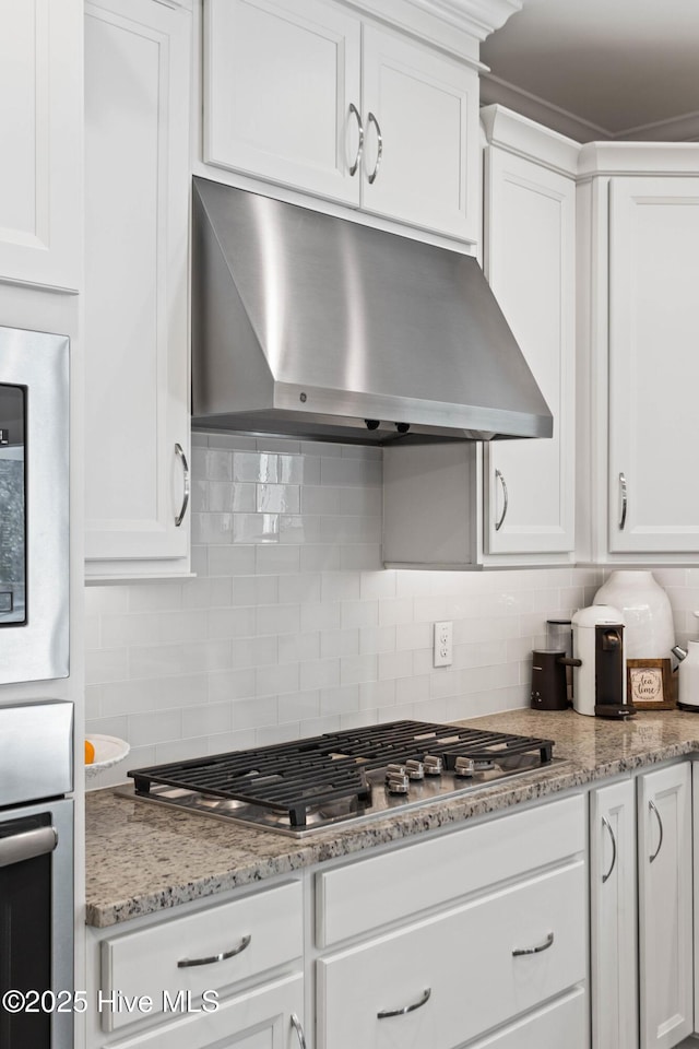 935 Baldwin Park Dr, Wilmington, NC 28411 - kitchen featuring under cabinet range hood, appliances with stainless steel finishes, backsplash, and white cabinetry