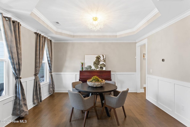 935 Baldwin Park Dr, Wilmington, NC 28411 - dining area with a chandelier, dark wood finished floors, a wainscoted wall, a tray ceiling, and crown molding