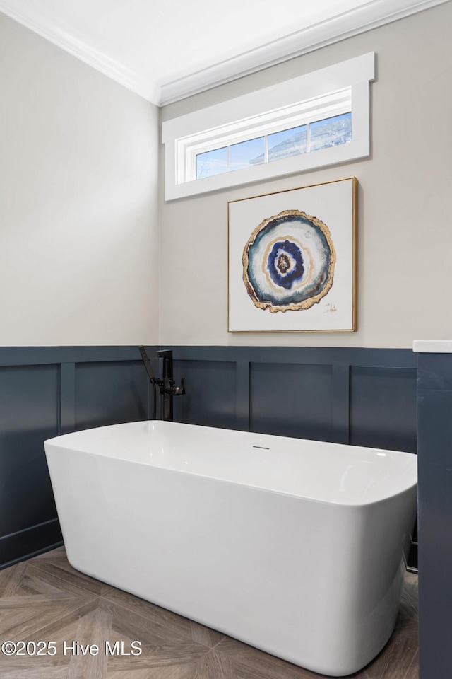 935 Baldwin Park Dr, Wilmington, NC 28411 - full bathroom with a decorative wall, crown molding, a soaking tub, and a wainscoted wall