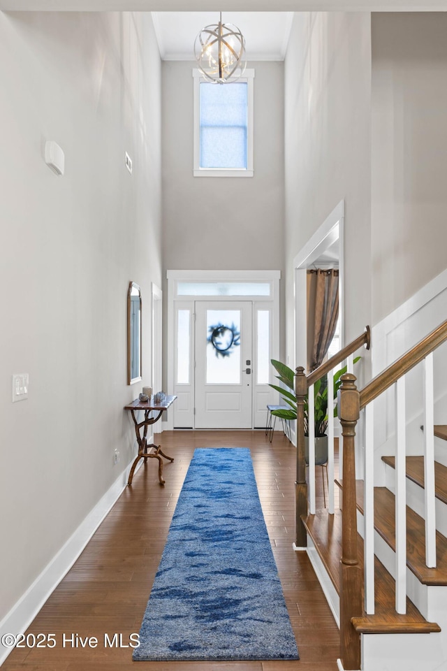 935 Baldwin Park Dr, Wilmington, NC 28411 - foyer entrance featuring a towering ceiling, crown molding, a chandelier, stairway, and baseboards