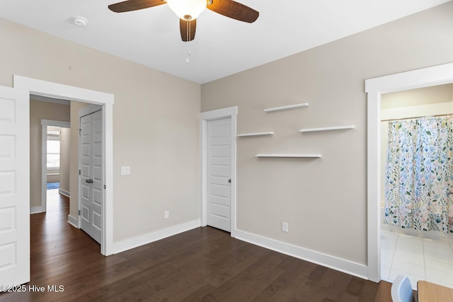 935 Baldwin Park Dr, Wilmington, NC 28411 - unfurnished bedroom featuring baseboards, dark wood-style floors, and a ceiling fan