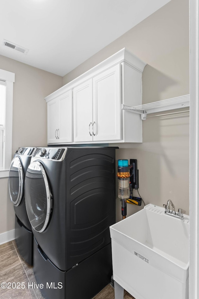 935 Baldwin Park Dr, Wilmington, NC 28411 - laundry area featuring separate washer and dryer, cabinet space, and baseboards