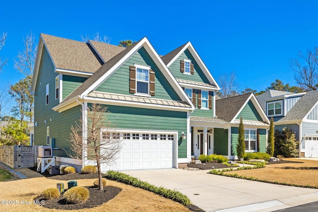 935 Baldwin Park Dr, Wilmington, NC 28411 - view of front of property featuring a standing seam roof, concrete driveway, an attached garage, and covered porch