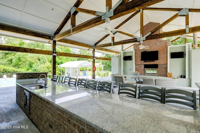935 Baldwin Park Dr, Wilmington, NC 28411 - view of patio / terrace featuring a gazebo, an outdoor kitchen, a ceiling fan, and an outdoor living space with a fireplace