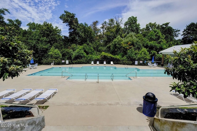 935 Baldwin Park Dr, Wilmington, NC 28411 - community pool featuring a patio area and view of wooded area