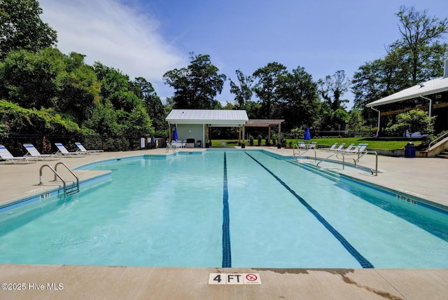 935 Baldwin Park Dr, Wilmington, NC 28411 - community pool with a patio area and view of wooded area