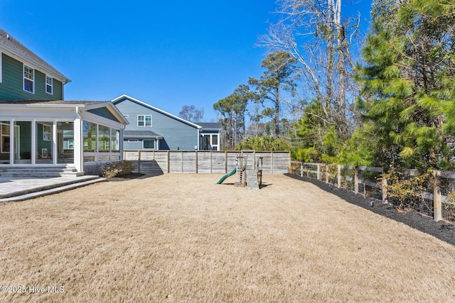 935 Baldwin Park Dr, Wilmington, NC 28411 - fenced backyard with a sunroom and a playground