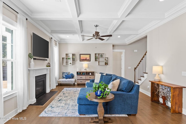 935 Baldwin Park Dr, Wilmington, NC 28411 - living area featuring a fireplace with flush hearth, a ceiling fan, wood finished floors, stairway, and beamed ceiling