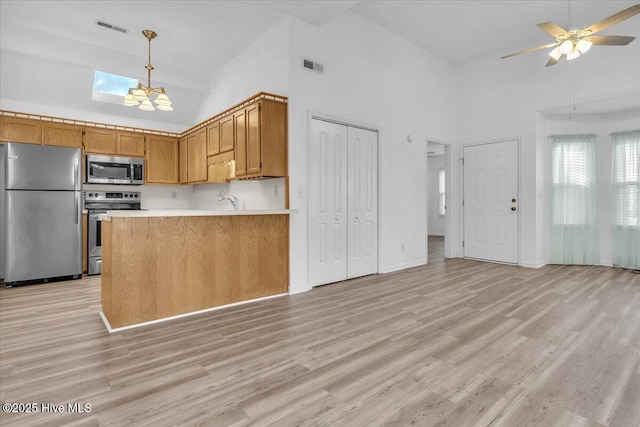 kitchen with light wood-style floors, visible vents, and stainless steel appliances