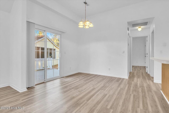 unfurnished dining area featuring light wood finished floors, baseboards, visible vents, and a notable chandelier