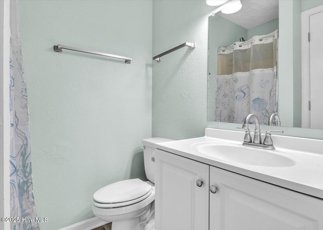 full bathroom featuring toilet, a textured wall, a shower with shower curtain, and vanity