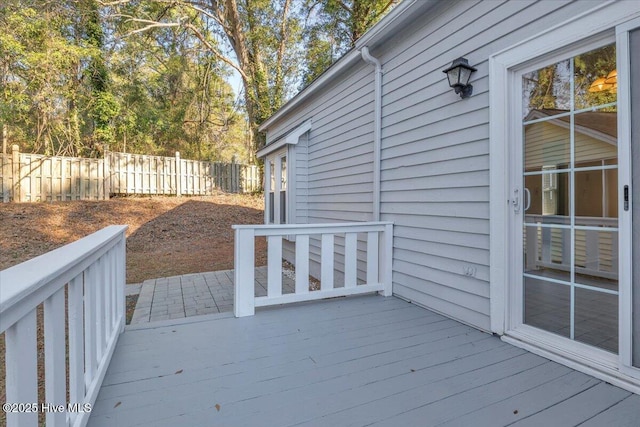 wooden terrace featuring fence