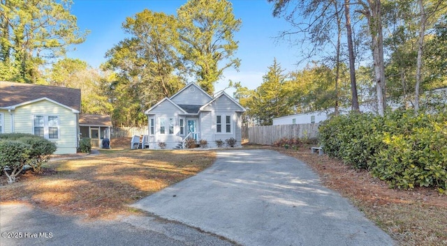 bungalow-style home featuring driveway and fence