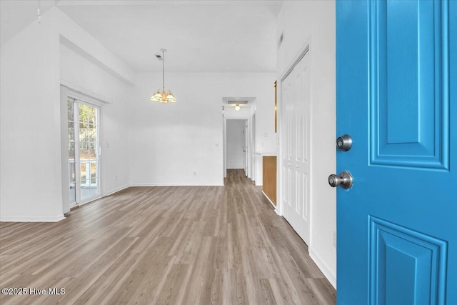 interior space featuring light wood-type flooring and baseboards