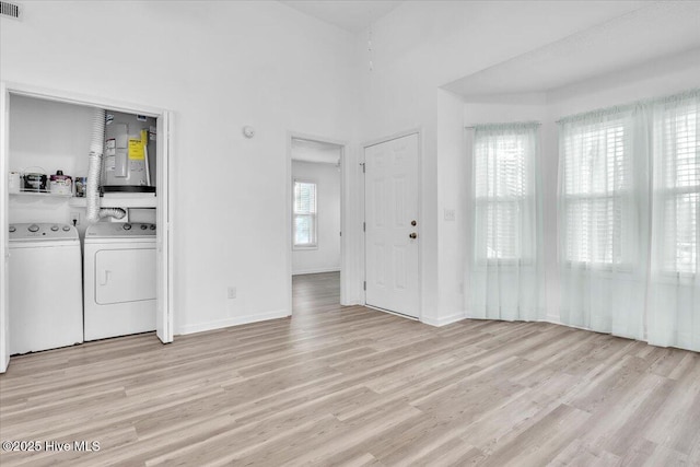 interior space with light wood finished floors, baseboards, and independent washer and dryer