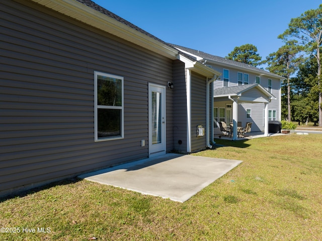 rear view of property with a patio area and a lawn