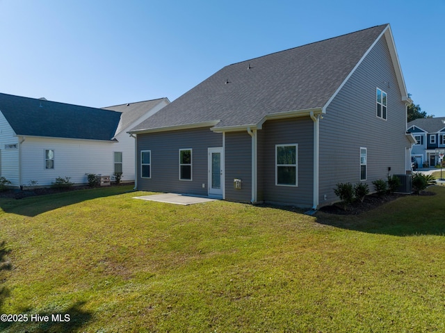 back of house with a shingled roof, a patio area, a yard, and central air condition unit