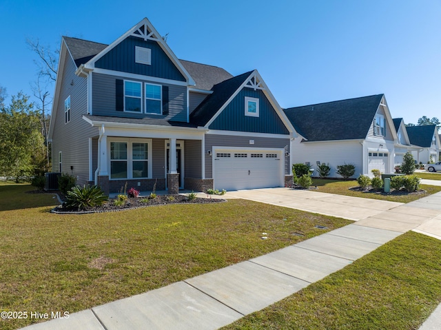 view of front of property featuring driveway, board and batten siding, a porch, a front lawn, and central AC