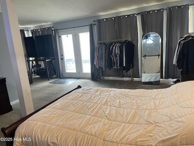 bedroom featuring a textured ceiling, carpet floors, baseboards, and access to exterior