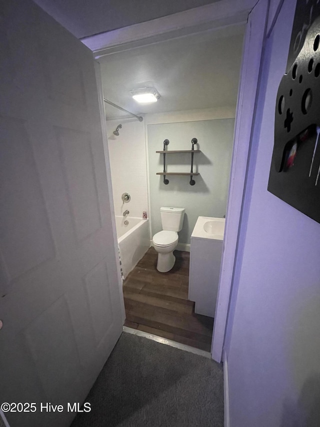 bathroom with vanity, shower / bath combination, wood finished floors, and toilet