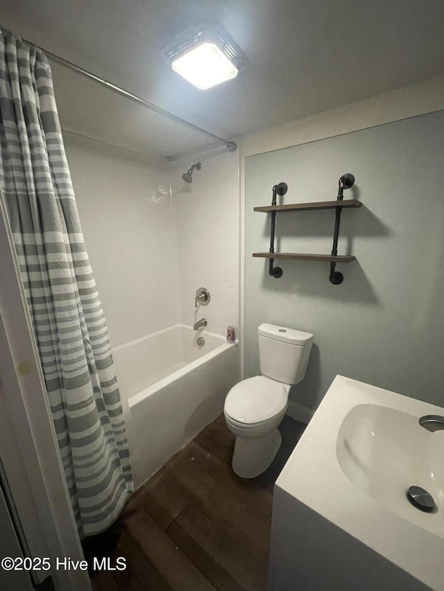 bathroom featuring toilet, shower / tub combo, a sink, and wood finished floors