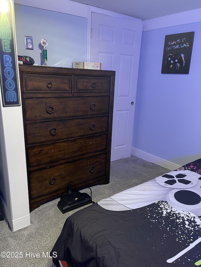 bedroom with carpet flooring and baseboards