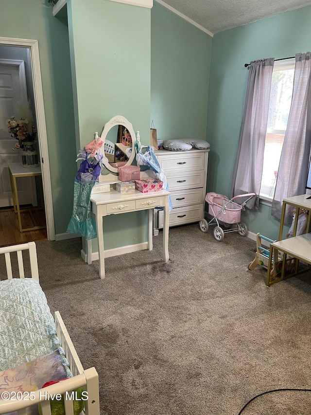 bedroom featuring baseboards, ornamental molding, a textured ceiling, and carpet flooring