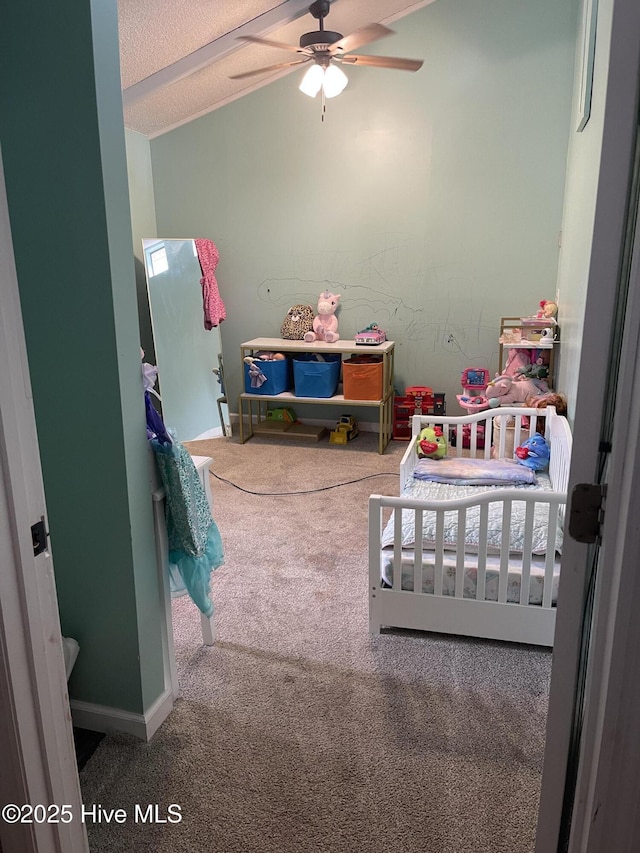 bedroom with carpet floors, baseboards, and a textured ceiling