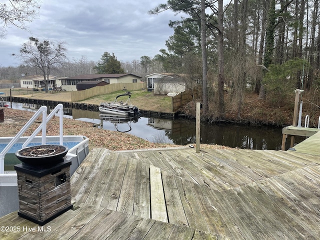 dock area featuring a water view and fence