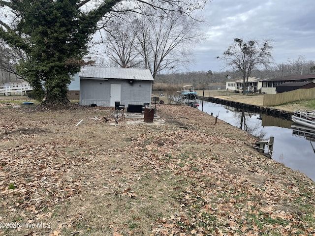 view of yard with a water view and fence