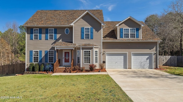 traditional home featuring concrete driveway, roof with shingles, a front yard, and fence