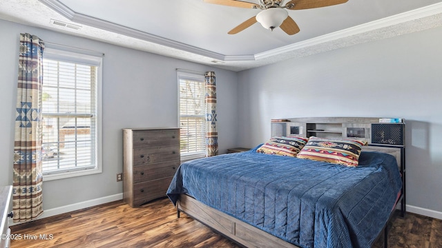 bedroom with dark wood-style floors, ornamental molding, visible vents, and baseboards