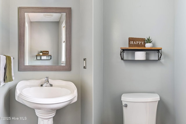 bathroom featuring toilet and a sink